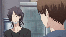 a man with a mask on his face smiles while talking to another man