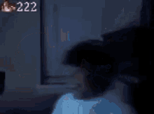 a person wearing headphones is standing in a dark room .