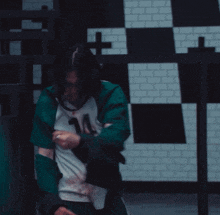a person wearing a green and white shirt with the number 124 on it