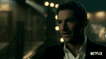 a man in a suit drinking from a glass with netflix written on the bottom