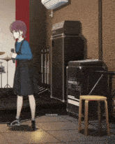 a girl in a blue shirt and black skirt is standing in a room with a drum set