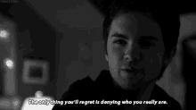 a black and white photo of a man with the words " the only thing you 'll regret is denying who you really are " below him