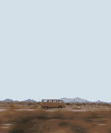 a van is driving down a road in the desert