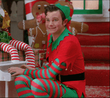 a young man dressed as an elf is playing a piano
