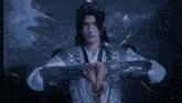 a man in a kimono is holding a sword in his hand
