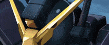 a close up of a black and gold robot with a yellow arrow pointing to the right