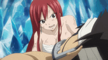 a woman with red hair is standing next to a man with a bandage on his arm