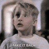 a young boy is wearing a sweater and saying `` i take it back ! ''