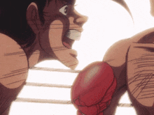 two boxers are fighting in a ring and one has red gloves