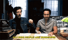 two men are sitting at a table with a map and the words all rich people are murderers