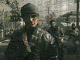 a man wearing a beanie and glasses is standing in front of a group of soldiers