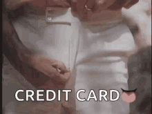 a man 's pants are being adjusted and the words credit card are visible