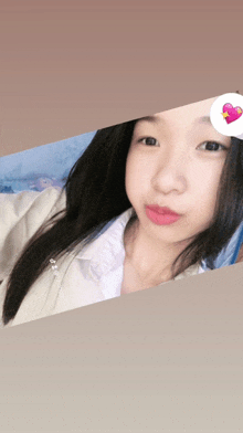 a picture of a girl with a pink heart on her face