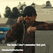 a man wearing sunglasses and a beanie talking on a phone with the caption " you know i don t remember that part