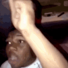 a close up of a person 's hand making a funny face .