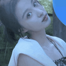 a woman with a blue balloon behind her
