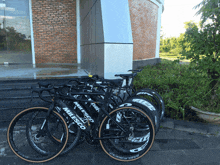 a row of milesco bicycles are lined up in front of a building
