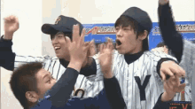 a group of baseball players with one wearing a ny jersey