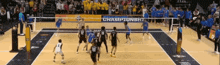 a volleyball game is being played in front of a banner that says " championship "