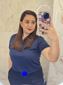 a woman taking a selfie with a phone case that says ' i love you '