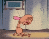 a cartoon character is kneeling down in front of a picture frame on the wall .