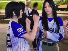 a girl wearing a blue and white jersey with the number 8 on it