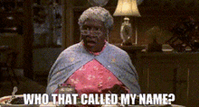 a woman is sitting at a table with a plate of food and a lamp and says `` who that called my name '' .