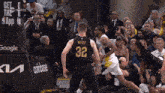 a basketball player wearing a number 32 jersey tries to get the ball