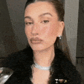 a close up of a woman 's face with a martini glass in her hand