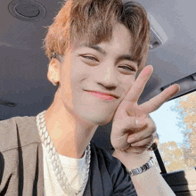 a young man wearing a bracelet that says ' i love you ' on it gives a peace sign