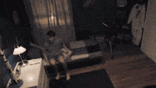 a man is laying in bed in a dark room