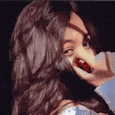 a woman with long hair is covering her mouth with her hand