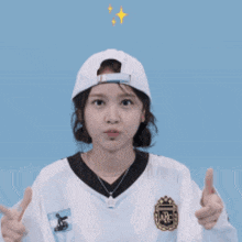 a girl wearing a baseball cap and a sweater that says archivo on it