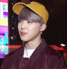 a close up of a person wearing a yellow hat and a red jacket