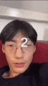 a close up of a person 's face with the number 2 on his forehead