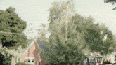 a blurry picture of a house and trees with the words ironheart on the bottom right