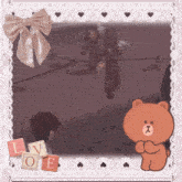 a picture frame with a brown teddy bear and the word love on it