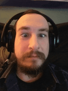 a man with a beard is wearing headphones