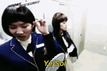 two girls in school uniforms are standing next to each other and one of them is saying ye sol