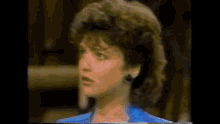 a close up of a woman 's face with a very large haircut .