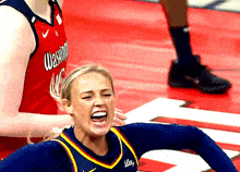 a female basketball player wearing a jersey that says washington on it