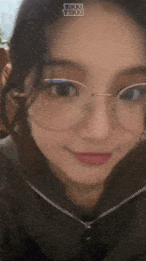 a close up of a woman wearing glasses .