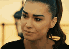 a woman is crying with a tear running down her cheek .
