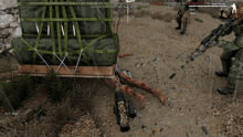 a screenshot of a video game shows a man laying on the ground with a sniper rifle in front of him