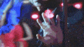 a blurry picture of a person 's hand reaching out towards a red light