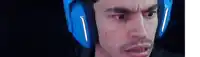 a close up of a man wearing blue headphones .