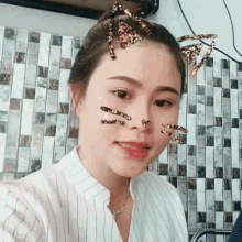 a woman with cat ears on her face is smiling for the camera