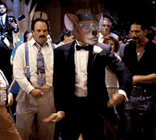 a man in a tuxedo with a dog 's head on his face