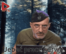 a man with glasses and a purple hat is sitting in front of a computer screen that says jebac praca kurwa