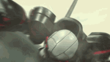 a close up of a robot 's helmet with a red stripe on it